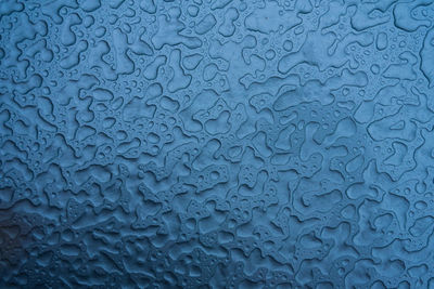 Full frame shot of raindrops on metal