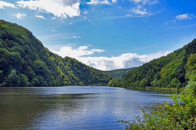 Scenic view of lake and mountains against sky