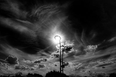 Low angle view of street light against cloudy sky