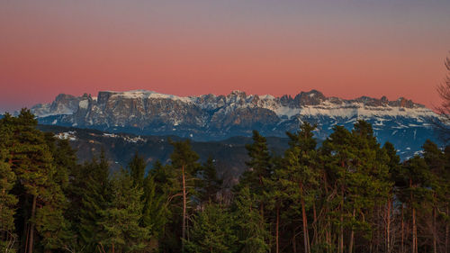 Scenic view of trees and mountains against sky during sunset