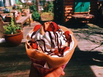 Cropped image of person holding ice cream