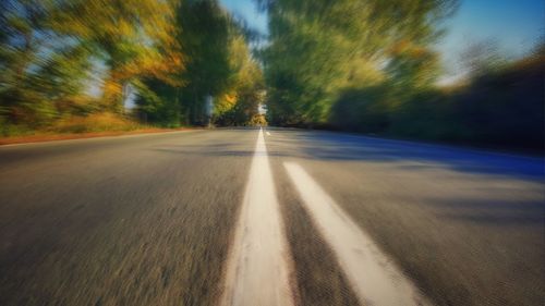 Road amidst trees against sky