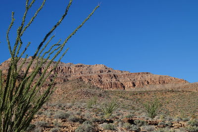 Low angle view of mountain against clear blue sky