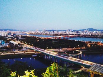 Bridge over river with cityscape in background