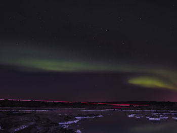 Aerial view of illuminated landscape against sky at night