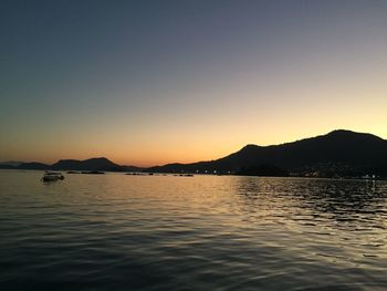 Scenic view of sea against clear sky during sunset