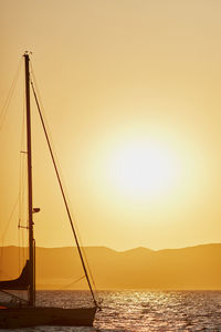 Sailboat on sea against sky during sunset