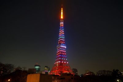 Low angle view of illuminated tower at night