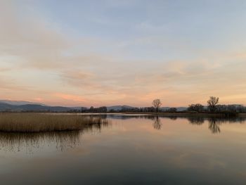 Scenic view of lake against sky during sunset