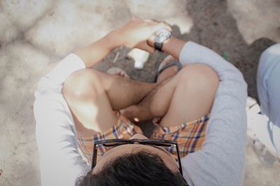 High angle view of man sitting on walkway