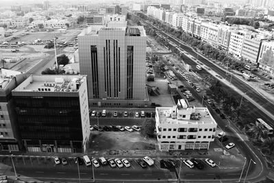 High angle view of vehicles on road along buildings