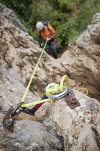 High angle view of man rappelling down the rock