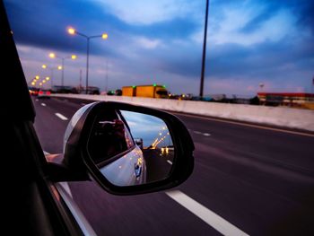 View of car on side-view mirror