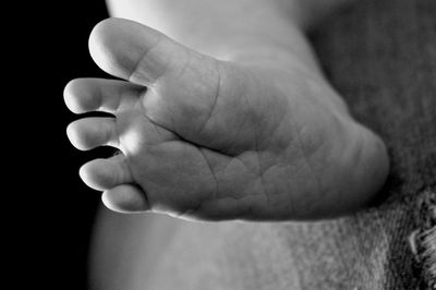 Close-up of baby feet on bed