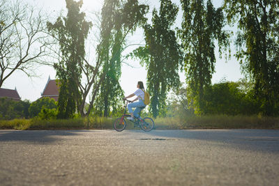 Spring is comming concept with happy and cheerful feeling of asian woman riding bicycle