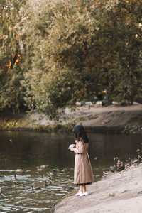 A happy single woman in elegant clothes walks in an fall park and in the forest in autumn outdoors