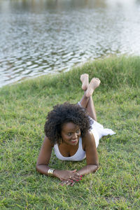 High angle view of woman lying on grassy field