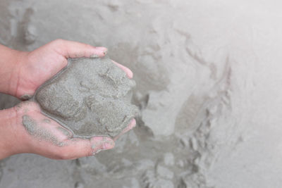 Close-up of hand holding sand