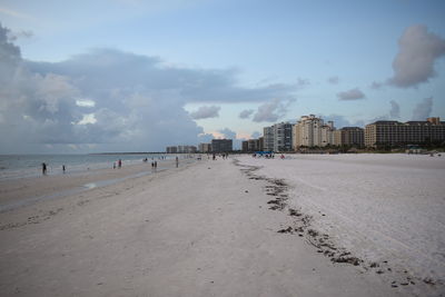 Scenic view of beach against sky in city