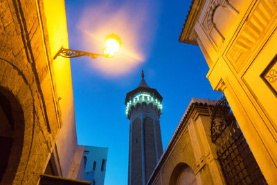 Low angle view of illuminated buildings against sky