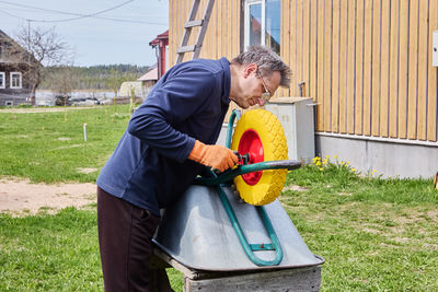 Side view of man working in park