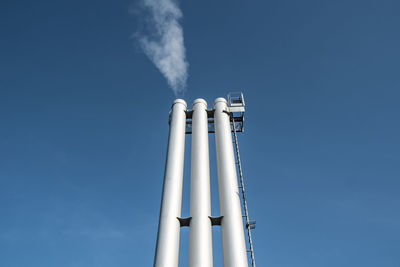 Low angle view of smoke stack against sky