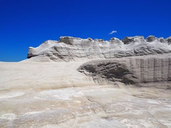 Rock formations against clear blue sky