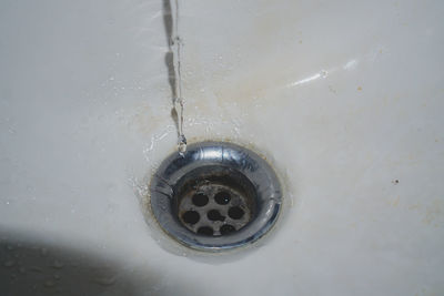 Close-up of water flowing from faucet at home