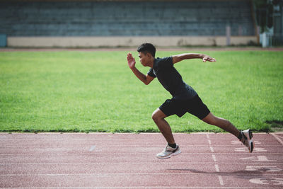 Full length of man running on grass