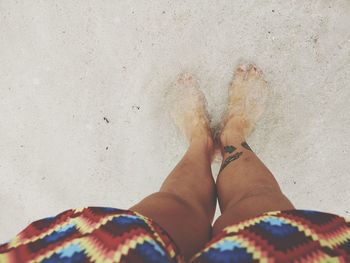 Low section of woman standing on beach