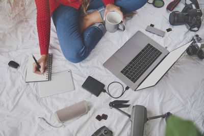 High angle view of people using laptop on table