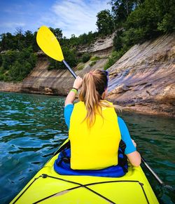 Rear view of woman with yellow umbrella