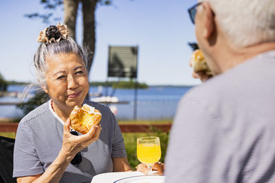 Senior couple having meal at camp site