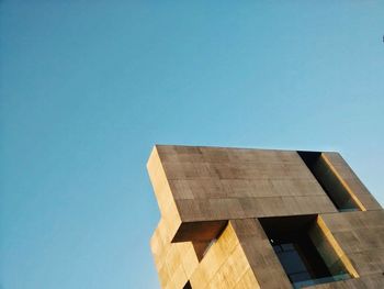 Low angle view of built structure against clear blue sky