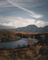 Scenic view of lake and mountains against sky