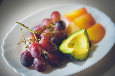 High angle view of grapes in plate on table