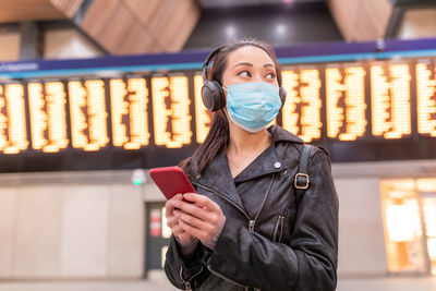 Portrait of a young woman using mobile phone