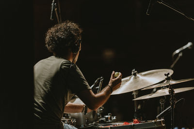 Man playing drums at music concert