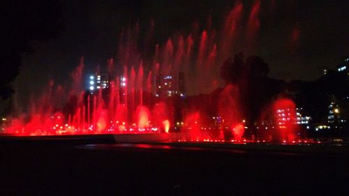 Low angle view of illuminated fireworks at night