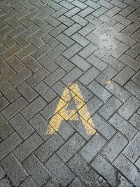 High angle view of arrow symbol on street