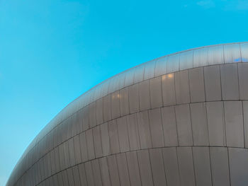 Low angle view of modern building against clear blue sky