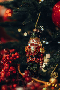 Christmas toy nutcracker hanging on the christmas tree. festive decor, new year details