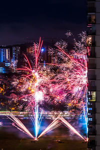 Firework display in city at night