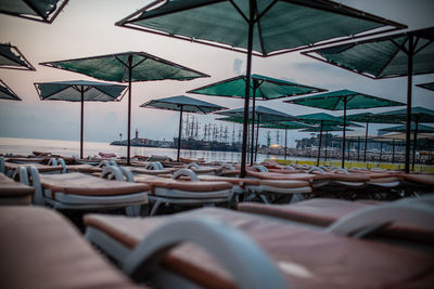 Lounge chairs at beach against sea