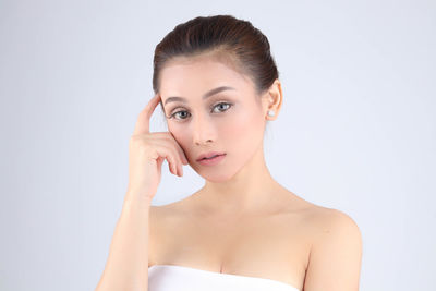 Portrait of a beautiful young woman over white background
