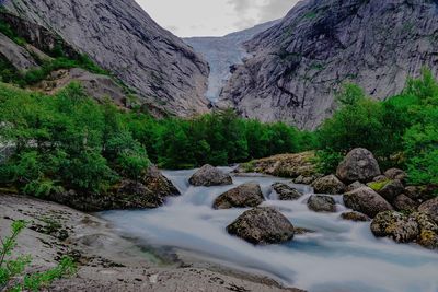 Scenic view of stream flowing through rocks