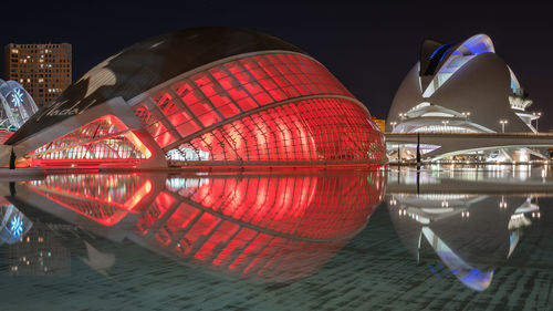 Reflection of illuminated building in water at night