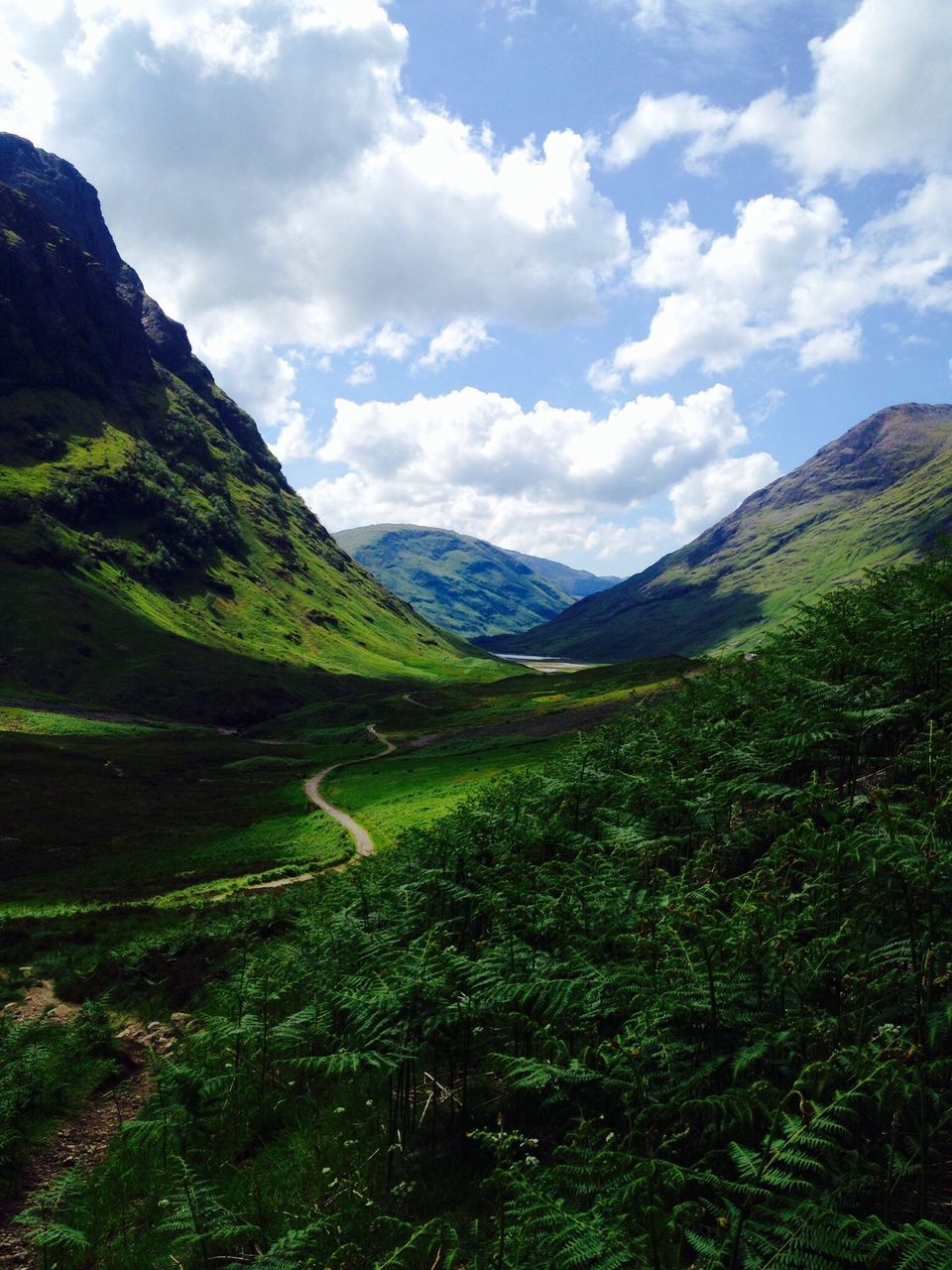 mountain, mountain range, tranquil scene, tranquility, scenics, sky, landscape, beauty in nature, green color, grass, nature, cloud - sky, non-urban scene, cloud, idyllic, cloudy, countryside, valley, remote, day