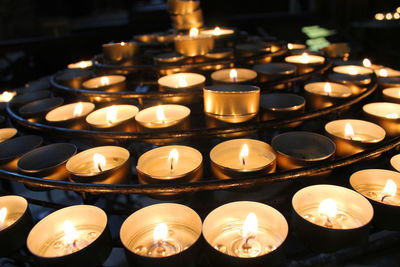 High angle view of illuminated candles in temple