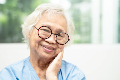 Asian senior woman wearing eyeglasses or vision glasses at home care service.